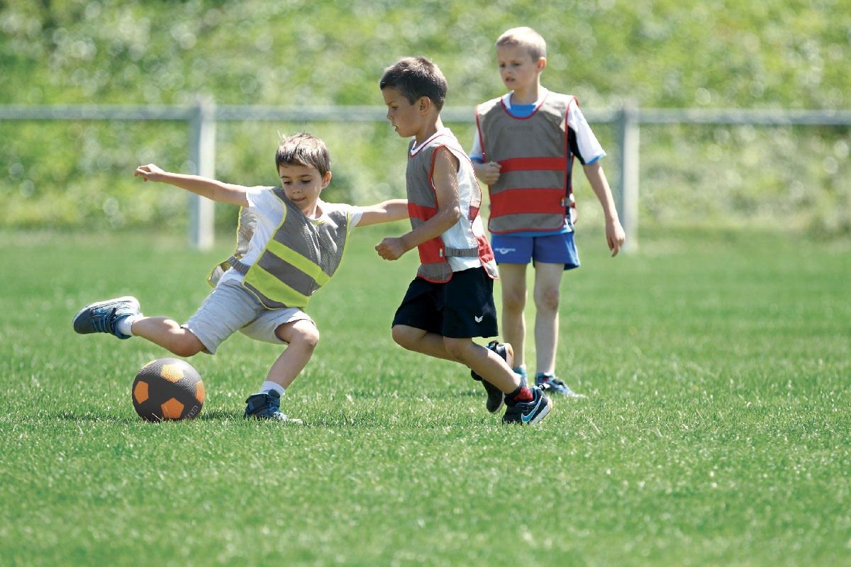 Enfants qui jouent au foot avec chasuble en tissu aéré et ballon de football street Soccer blog Wesco